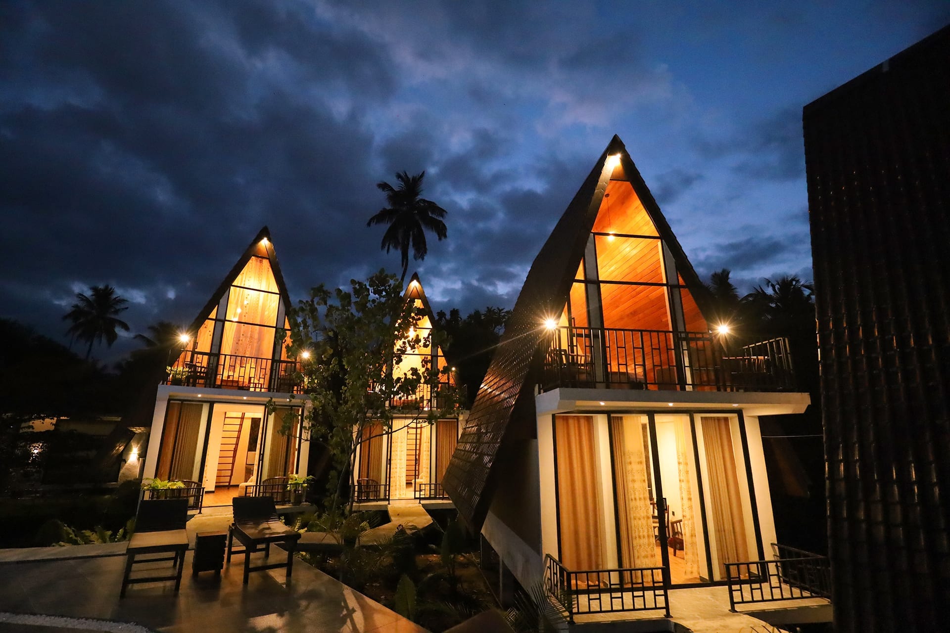 Twin A-frame chalets at dusk