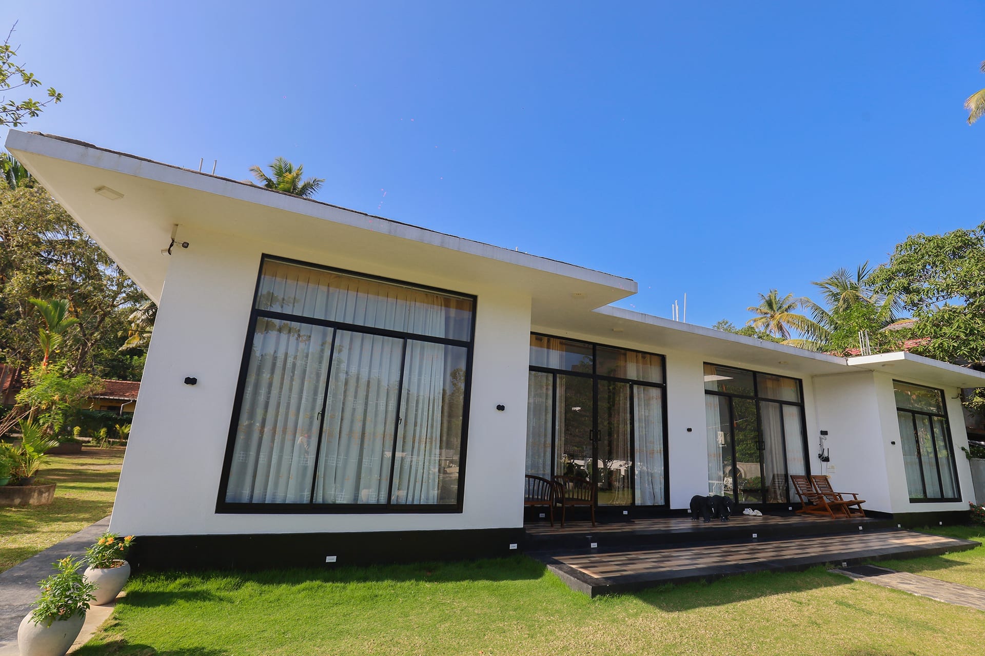 Deluxe Garden Suite exterior with tropical garden and blue sky