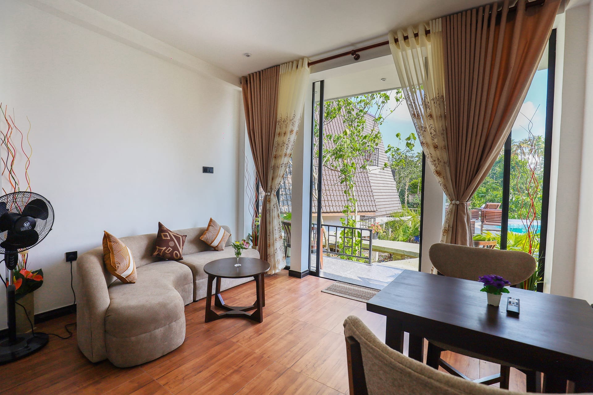 Deluxe Garden Suite — open-plan living area with pool view